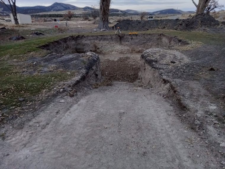 Building pad cut and stripped, spoils stockpiled on site.