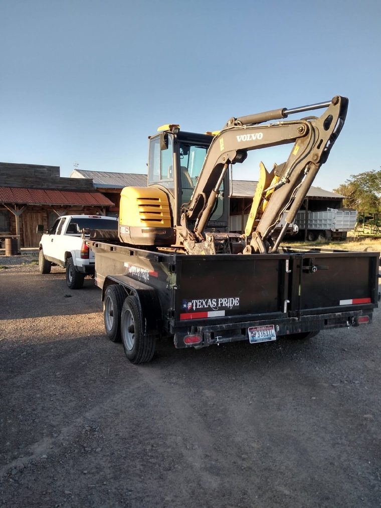 Mini excavator loaded and headed to a job site.