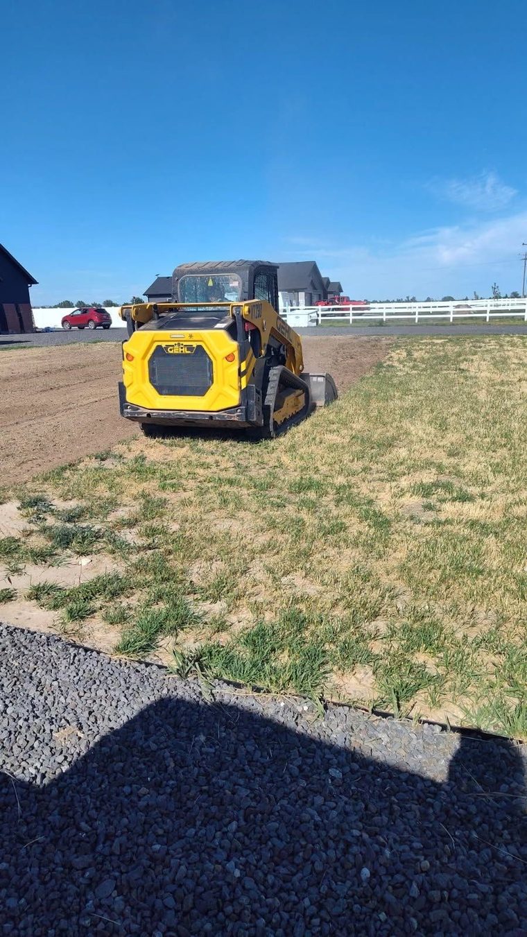 Grading and gravel work on a residential property.
