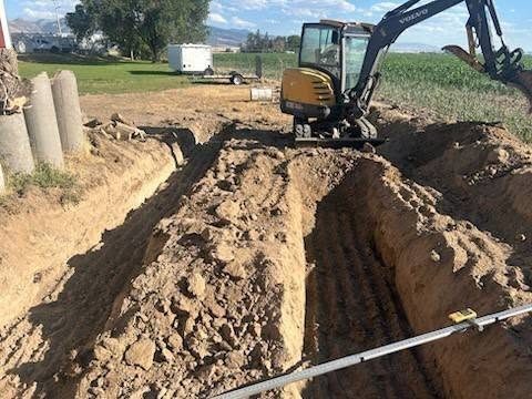 Trenching along a property line with the mini excavator.